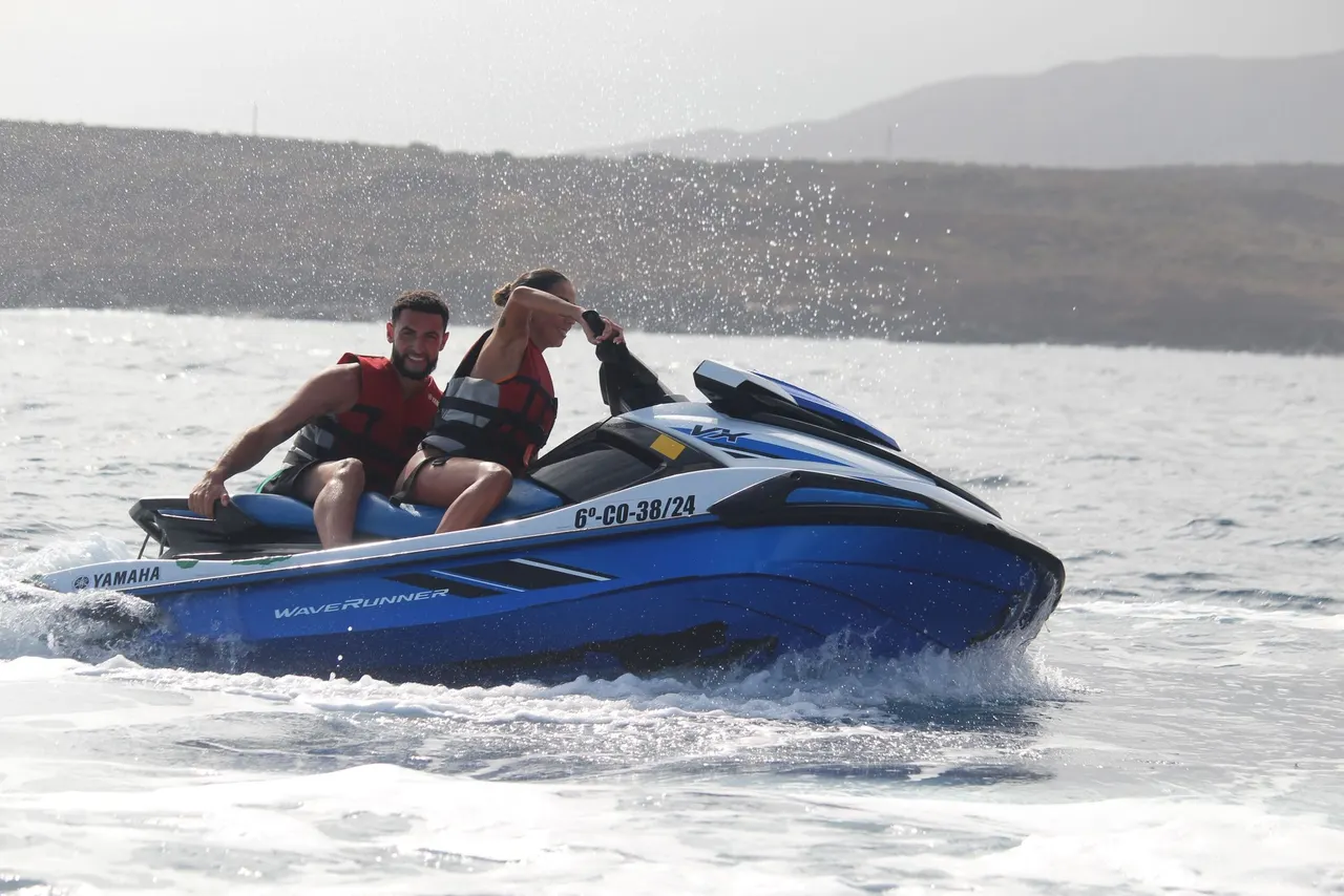 Two riders on a blue Yamaha WaveRunner