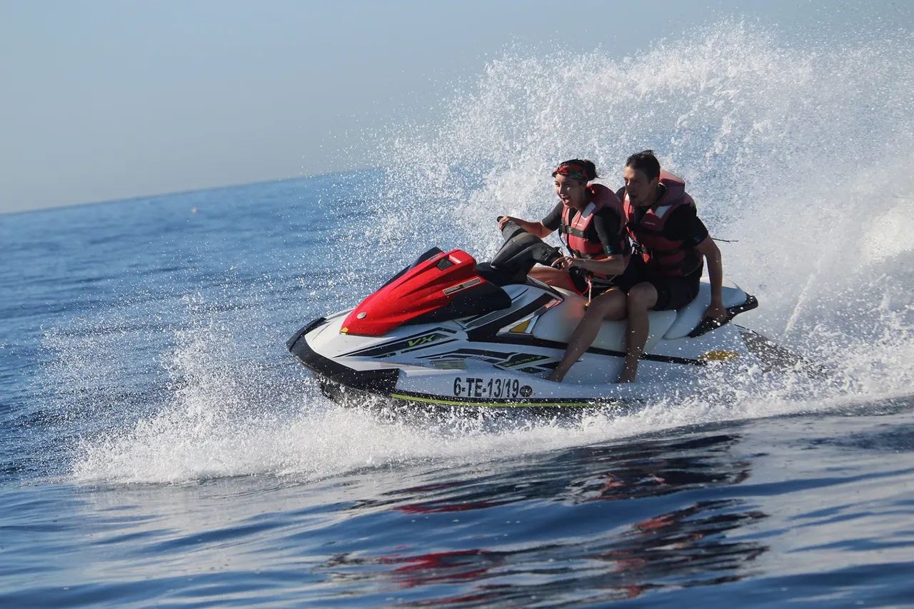Two riders on a Yamaha close to the coast